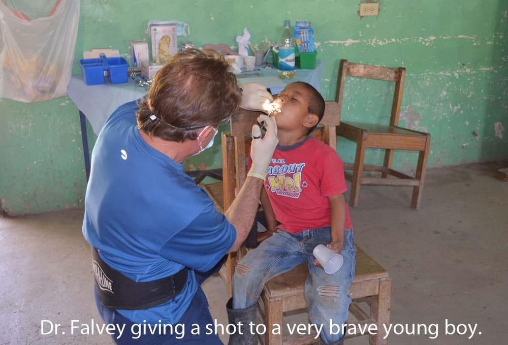 Dr. Falvey giving a shot to a child on a Honduras mission trip