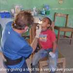 Dr. Falvey giving a shot to a child on a Honduras mission trip