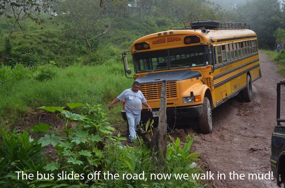 A bus that slid off of the road due to mud