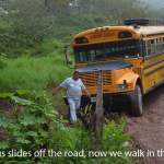 A bus that slid off of the road due to mud