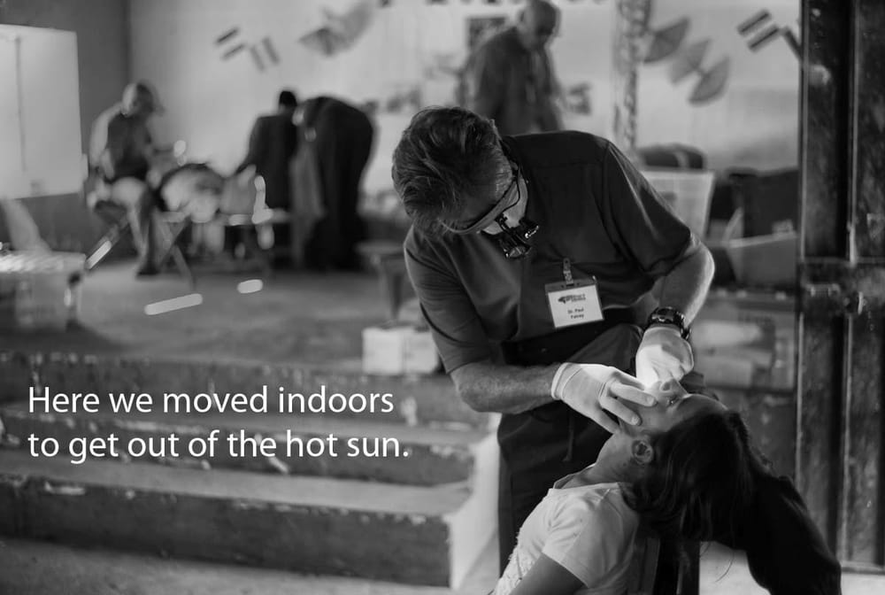 Dr. falvey working with a patient indoors during a Honduras Mission trip