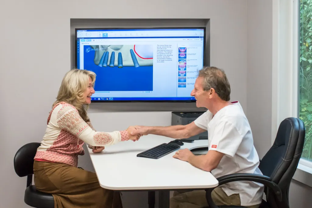 Dr. Falvey shaking hands with a patient