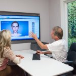 Dr. Falvey reviewing scanner results with a patient