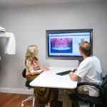 Dr. Falvey reviewing scanner results with a patient